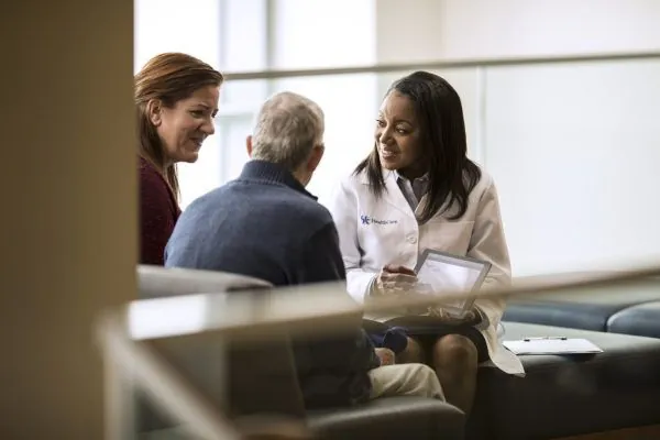 Clinic handoff status card showing urgent patient concern routed to staff review